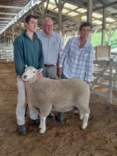 Annabel Tripp presents the Perendale ram she sold for $19,000 to John Henricksen (centre). The...
