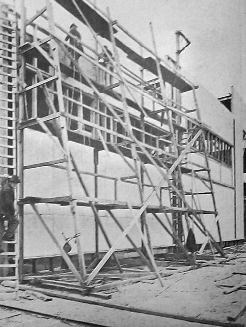 Rail-mounted scaffolding in use at the New Zealand and South Seas Exhibition construction site on...
