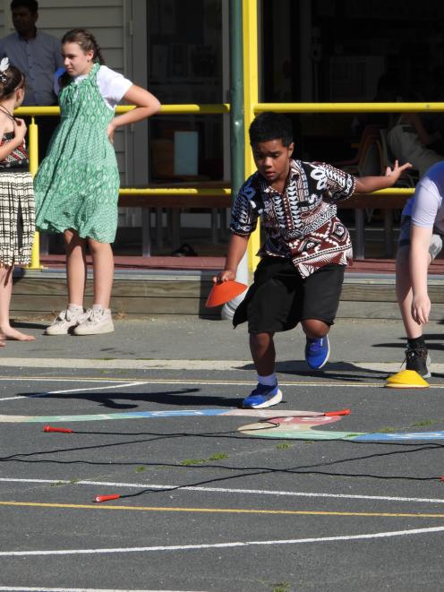 Tua Tawaketini, 9, dashes forward during a tic tac toe game.