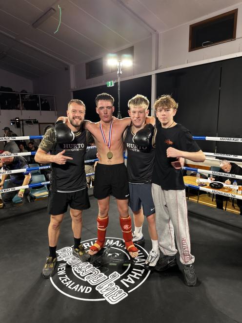 Hurto Gym owner Rob Horrocks, left, with winning fighters Marcel Main and Otis Clairbrough, and...