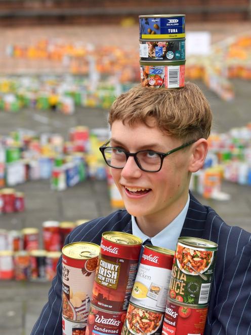 King’s High School student Gregor Watts, 15, displays some of the 3685 cans collected by his...