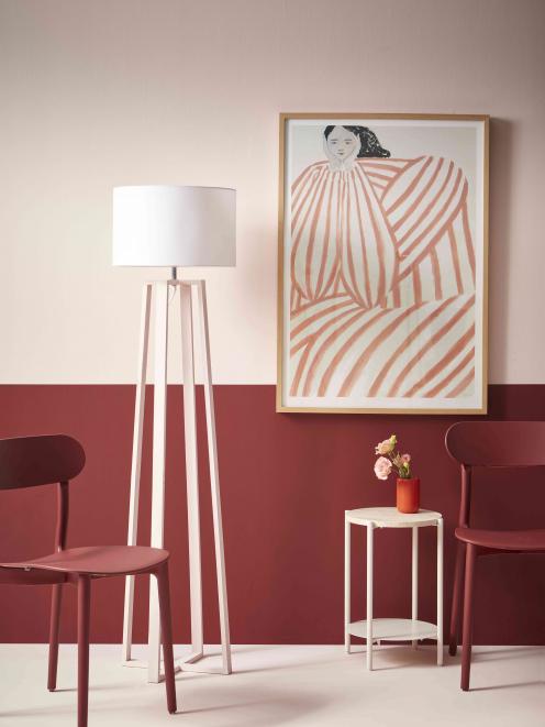 A bold red effectively anchors the ethereal pink of this room. Upper wall, floor, table and...