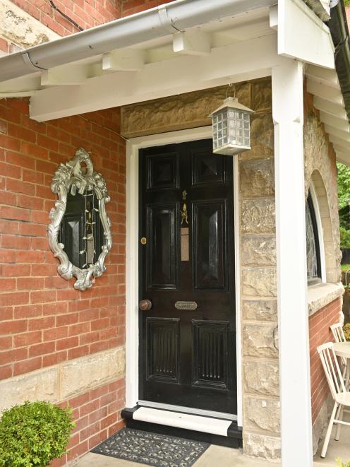 The exterior detailing includes rough-hewn Oamaru stone arches and quoining.