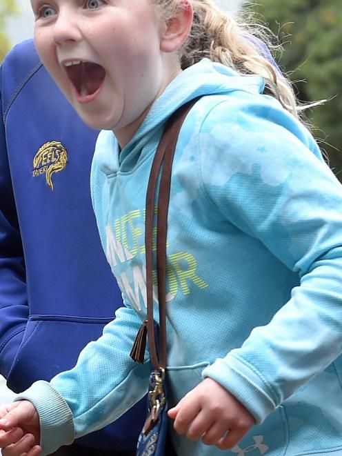 Kaikorai Primary School pupil Libby Allison (10) reacts when a fellow pupil is soaked at the...