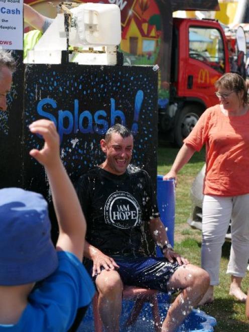 Refreshing... Saddle Hill Community Board chairman Scott Weatherall cools off at the community...