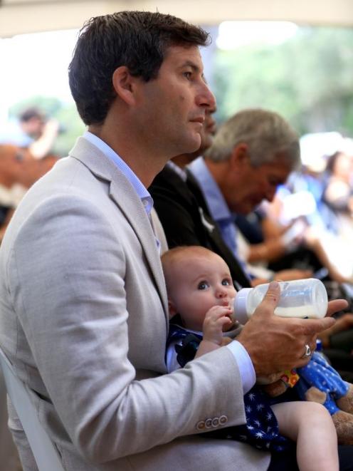 The Prime Minister's partner Clarke Gayford feeds their daughter Neve on the upper marae. Photo:...