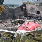 The wreckage of the crashed Air India plane is being lifted by a crane from the roof of the BJ...
