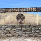 A sign at the end of its main street welcomes visitors into the historic gold-mining town. Ophir...