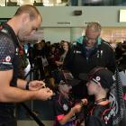 Warriors player Simon Mannering signs an autograph for Darcy (6) and Alex (8) Tavendale as their parents Matthew and Adrienne look on. Photos by Linda Robertson.