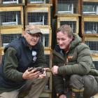 Yellow-eyed Penguin Trust field manager David McFarlane (left) and New Zealand Deerstalkers' Association Otago branch senior vice-president Greg Fagg inspect a mark 6 Fenn trap. Photos by Peter McIntosh.