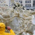 A man takes a picture of sea spray as storms hit Cape Town. Photo: Reuters