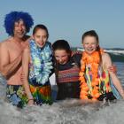Polar plungers (from left) Mike McConachie, Tessa McConachie (14), Emma Andrews (13) and Annabelle Bilkie (14), all of Dunedin, are all smiles despite the chilling water of St Clair Beach at the 88th Polar Plunge yesterday. Photos: Gregor Richardson
