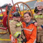 Dunstan Rural Fire Force firefighter Melanie Hall and her daughters Charlotte McGinnis (2)  and Michaela McGinnis (6), enjoy the Alexandra Volunteer Fire Brigade open day on Saturday. Photos: Pam Jones