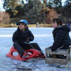 Tom (7) and Eddy (5) Smale, of Lauder, are towed over the ice. Photos: Jono Edwards