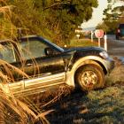 A SUV in a ditch beside slippery State Highway 1 in East Taieri yesterday. Photos: Stephen Jaquiery.