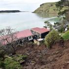 A slip tore through a cottage in Cape Saunders Rd, splitting it in two and knocking it off its...
