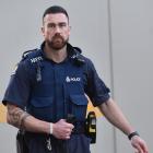 Constable Regan Mauheni and his 10-month-old German Shepherd pup Paikea. Photo: Peter McIntosh.
