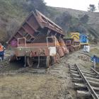 A wagon dumps fill for repairs on the railway line.
