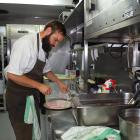 Ode chef Lucas Parkinson prepares a fish dish in the test kitchen. Photos: Kerrie Waterworth.