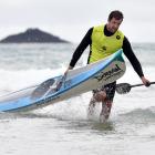 Surf ski event winner Andrew Newton, formerly of St Clair but now of Tauranga, arrives back on the beach. Photos: Peter McIntosh