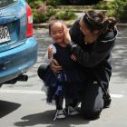 Ashley Papara embraces her daughter Tilly after she was rescued by firefighters from a car parked...