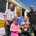 Brooke McIntyre (8) shows off the fish she caught in the Clutha River to her sister, father and grandparents (from left) Jonny, Jaclyn (5) and Margaret and Scott McIntyre at the Millers Flat Holiday Park. Photos: Pam Jones