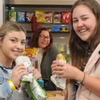 Campus Wonderful Store manager Simone Omipi (middle) serves hungry students Brenna Edmonds (left) and Sian Sunckell. Photo: Christine O'Connor