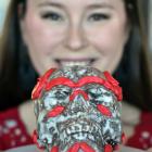 PhD student Jade De La Paz (left) shows off with her cake which tied into her work on estimating biological sex by studying the skull. Photos: Peter McIntosh