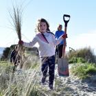 Dunedin girl Mackenzie Hepburn lends a hand during a planting project in St Clair on Saturday. 