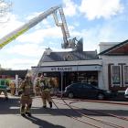 Firefighters rip open the roof of popular Dunedin restaurant No7 Balmac to battle a blaze there...