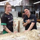 Once it's off the sheep, Molly Tapuke (left) and Amy Ferguson make sure there is nothing caught...