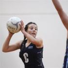 Caitlin Thomson (14), of Otago Girls' High School, looks to lob the ball past Arnika Buchan (14),...