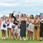 Supporters cheer on their favourites at the Fashions in the Field event at Wingatui. PHOTOS:...