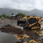 Heavy machinery clears debris from the Wanaka lakefront this afternoon. Photo: Gregor Richardson