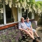 Myra and Richard Wells, of Abbotsford, under their white wisteria. Photo: Gillian Vine 