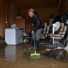 Karla Graves, of East Gore, gets down to the task of cleaning up her garage after floodwater...
