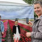 Anna Murdoch takes a picture of Emily Irvine (11, left) and Mia Murdoch (6) at the Triflor’s...