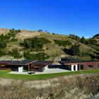 Nestled against a tussock-covered hill, this steel-clad Queenstown home sits perfectly within its...