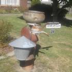 A milk separator and steel bucket feature in a mailbox in Ranfurly. PHOTO: HELEN CROMB