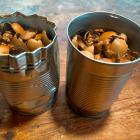 Two tins full of nuts shells waiting for their turn in the wood burner. 