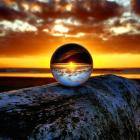 Sphere of influence ... The final sunset of 2022 on New Year’s Eve is viewed through a lens ball...