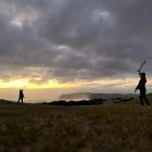 Sisters Annabel (16) and Isla (13) Ludgate playing in the twilight at Chisholm Park Golf Course,...