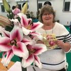 First-time exhibitor Sandra Wallis with her Oriental lily stem that scooped the pool at Saturday...