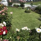 Few of the gardens have lawns. This one at Liz and Rod Lester’s is surrounded by flowers.