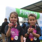 Twins, Sarah and David Jenkins (6), proudly display their medals after completing the Total Life...