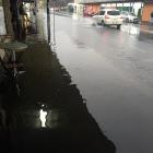 Flooding covers the footpath and reaches shopfronts in North Rd , Dunedin, yesterday evening....