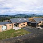 A modern take on traditional gable forms, the home makes the most of the site’s outstanding views.
