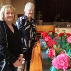 Judy Dickson, of Waikaka, and Val Tytler, of Gore, admire the rhododendron blooms on display....
