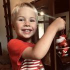 Festive touch ... Nate Roy, 3, puts up Christmas decorations in his home in Moonlight on...