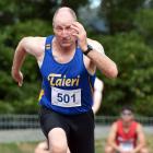Local athlete Paul Davies, of Taieri, takes off in the 100m sprint.